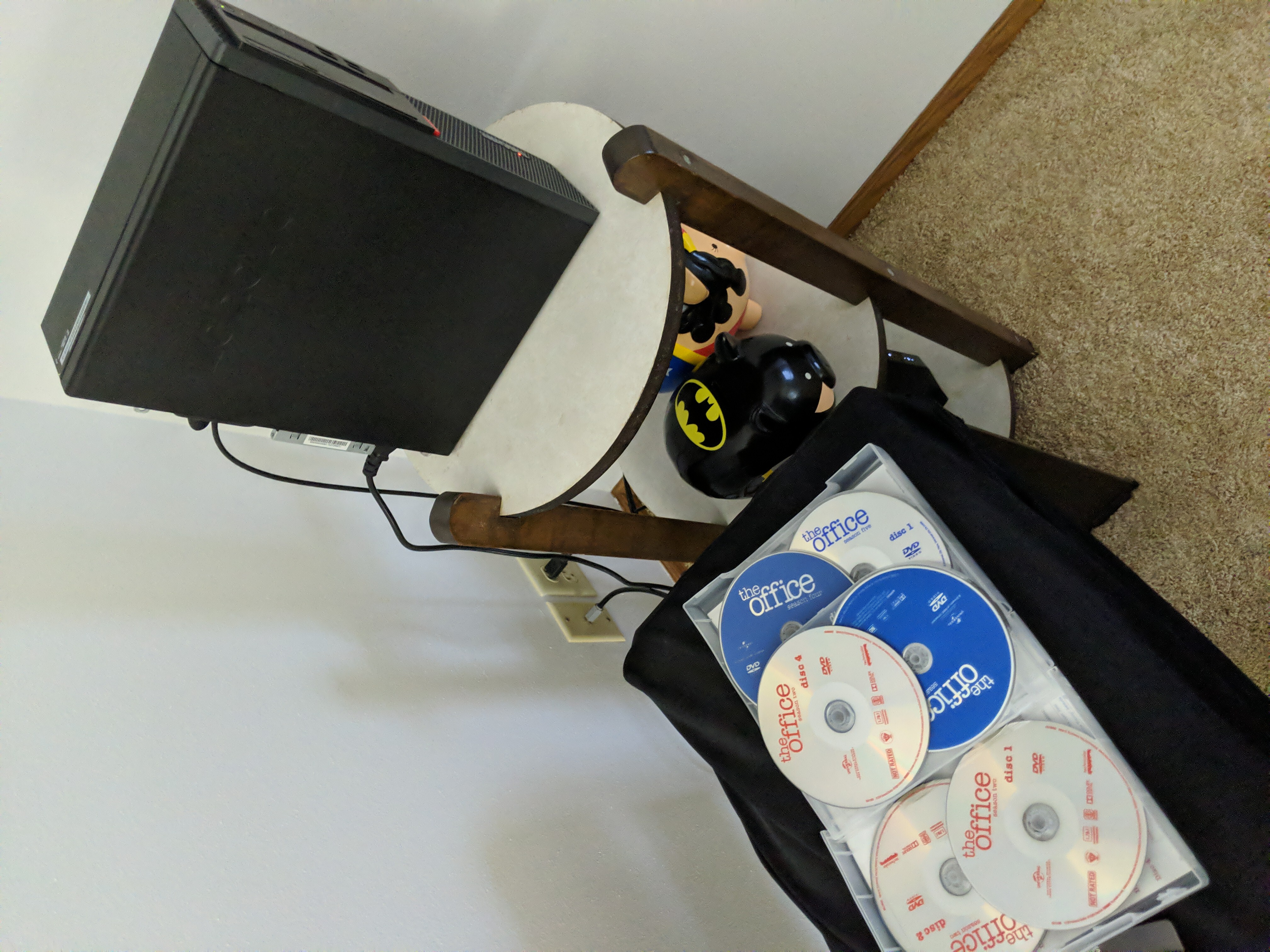 Lenovo ThinkCentre precariously perched on a side
table